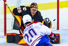 Calgary Flames goaltender Jacob Markstrom reaches out for a shot by Montreal Canadiens forward Juraj Slafkovsky at the Scotiabank Saddledome in Calgary on Dec. 1, 2022. 