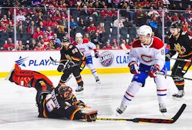 Jacob Markstrom of the Calgary Flames leaves his net to stop a shot from Sean Monahan of the Montreal Canadiens during the first period at Scotiabank Saddledome in Calgary on Dec. 1, 2022.