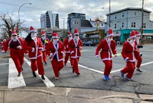 Participants in the Ho Ho Holiday 5K take off down Quinpool Road on Saturday, Dec. 5, 2022. - Jen Taplin