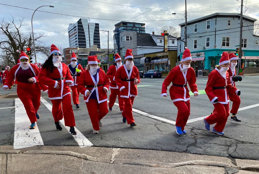 Participants in the Ho Ho Holiday 5K take off down Quinpool Road on Saturday, Dec. 5, 2022. - Jen Taplin
