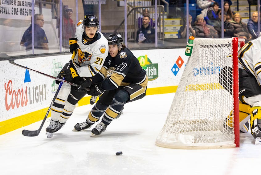 Charlottetown Islanders forward Lucas Romeo, 17, and Victoriaville Tigres defenceman Thomas Belzile, 21, race for the puck during a Quebec Major Junior Hockey League (QMJHL) game at Eastlink Centre on Dec. 2. The Tigres won the game 4-1.  Charlottetown Islanders photo