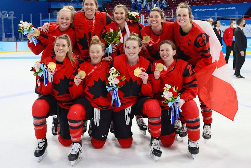  Gold medal winners Emma Maltais #27, Brianne Jenner #19, Jamie Lee Rattray #47, Laura Stacey #7, Marie-Philip Poulin #29, (front) Natalie Spooner #24, Sarah Fillier #10, Claire Thompson #42 and Erin Ambrose #23 of Team Canada celebrate during the medal ceremony after the Women’s Ice Hockey Gold Medal match between Team Canada and Team United States on Day 13 of the Beijing 2022 Winter Olympic Games at Wukesong Sports Centre on February 17, 2022 in Beijing, China. (Photo by Bruce Bennett/Getty Images)