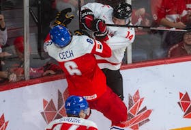Canadian forward Zach Dean hits Czechia's Ales Cech during the second period of Monday's IIHF world junior championship game at Scotiabank Centre. Dean was assessed a match penalty and was ejected from the game as a result. - RYAN TAPLIN / THE CHRONICLE HERALD