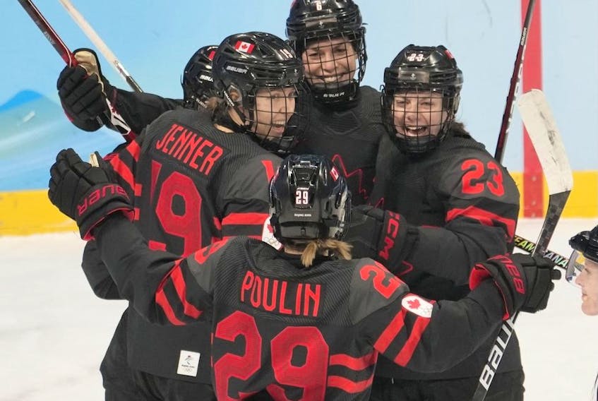 Team Canada players Brianne Jenner (19), Marie-Philip Poulin (29) and Erin Ambrose (23) celebrate a goal against Sweden during first period women's quarter-final round hockey action at the Beijing Winter Olympics in Beijing, China, on Friday, Feb. 11, 2022.