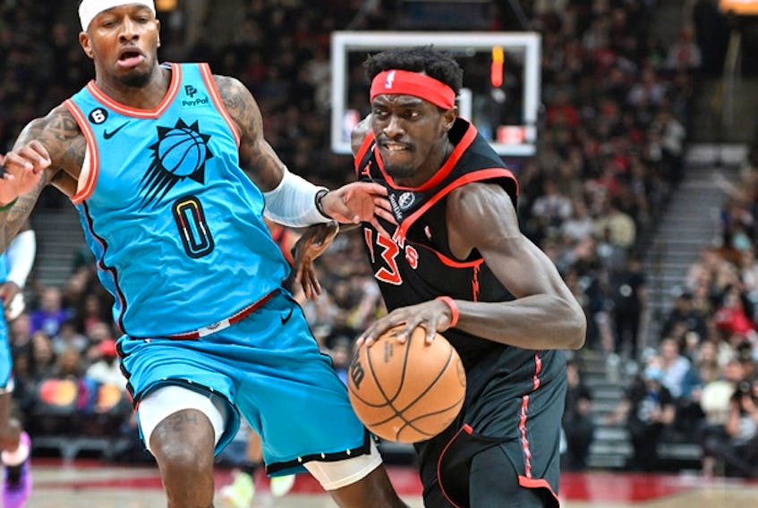 Raptors forward Pascal Siakam (right) dribbles past Phoenix Suns forward Torrey Craig during the first half at Scotiabank Arena on Friday night.