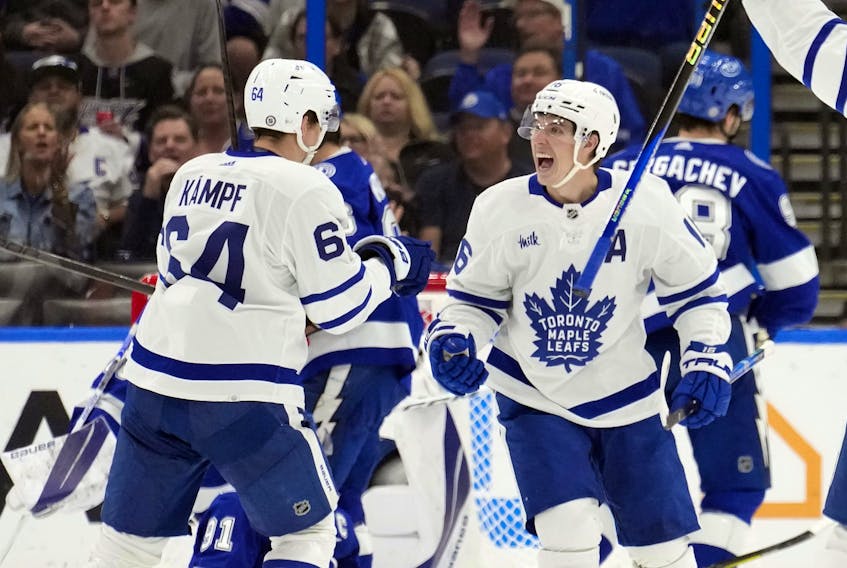 Maple Leafs' Mitch Marner (right) celebrates his goal against the Tampa Bay Lightning with teammate David Kampf during the second period on Saturday, Dec. 3, 2022.