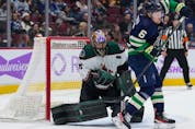  Arizona Coyotes goalie Karel Vejmelka, left, of the Czech Republic, makes the save as Vancouver Canucks’ Brock Boeser tries to tip the puck past him during the first period of an NHL hockey game in Vancouver, on Saturday, December 3, 2022.