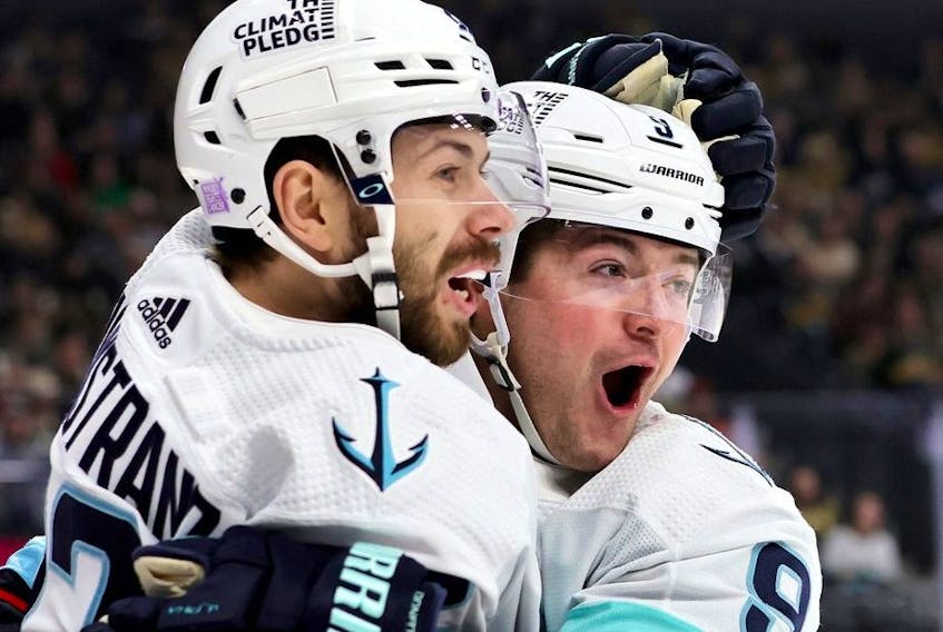Oliver Bjorkstrand and Ryan Donato of the Seattle Kraken celebrate Donato's first-period goal against the Vegas Golden Knights during their game at T-Mobile Arena on November 25, 2022 in Las Vegas, Nevada. 