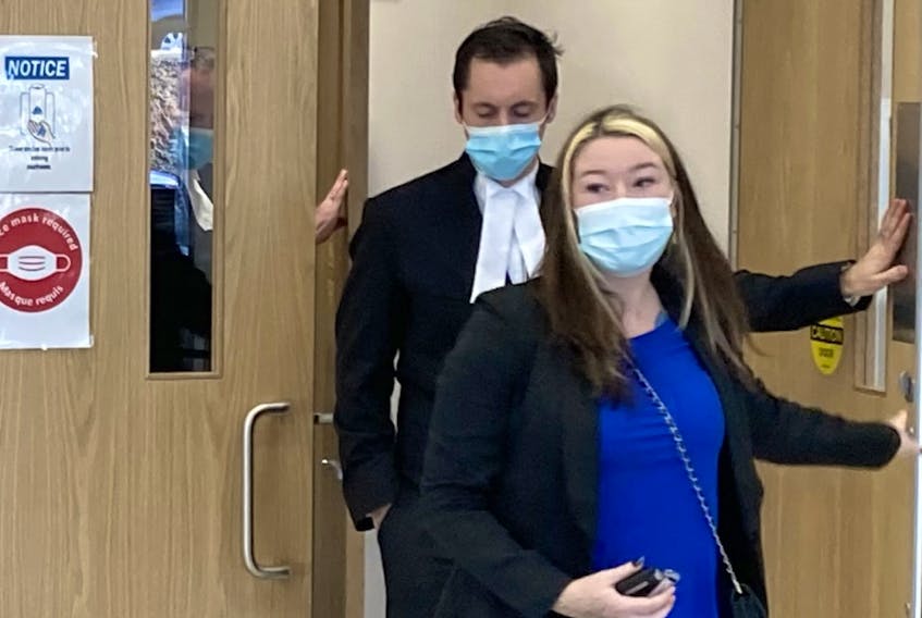 Miranda Lynn Taylor leaves her trial in Nova Scotia Supreme Court in Dartmouth on Monday with lawyer Alex Pate. The 24-year-old Annapolis County woman is charged with being an accessory after the fact to murder and two counts of intimidating a justice system participant.