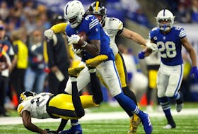Pittsburgh Steelers outside linebacker T.J. Watt prepares to punch the ball after a catch by Indianapolis Colts tight end Jelani Woods during the second half at Lucas Oil Stadium.  