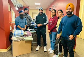 Members of the Sukhmani Sahib Society during their winter clothing giveaway at the YMCA in Sydney, held Nov. 26-27. From left are Gurmeet Singh, Amrit Janjua, Dikshat Chawla, Saloni, Nisha and Amrinder Singh. CONTRIBUTED