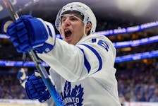 Mitch Marner celebrates his third-period goal against the Tampa Bay Lightning on Saturday night. Marner recorded at least a point in 19 consecutive games to set a new Maple Leafs record.