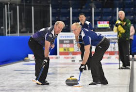 Nova Scotia’s Stuart MacLean, left, and Peter Neily wait for sweeping instructions from skip Glen MacLeod during a game against Northern Ontario’s Al  Hackner at the Everest Canadian Senior Curling Championship on Monday in Yarmouth.   – Tina Comeau