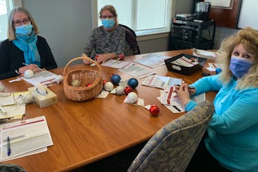 Members of the fundraising committee at the Northside Guest Home gathered recently. From left, Catherine Collins, Erma Carmichael and Joan Mushbally are pictured here preparing for the Bells of Care event. CONTRIBUTED