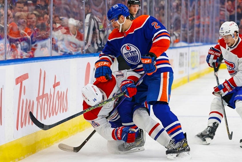 Edmonton Oilers defencemen Evan Bouchard (2) checks Montreal Canadiens forward Nick Suzuki on Dec. 3.
