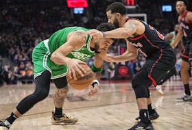 Boston Celtics forward Jayson Tatum (0) tries get around Toronto Raptors guard Fred VanVleet on Monday night. 
