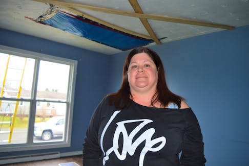 Lynette Borgal is hopeful her roof and living room will be fixed in another week, which would be 18 days since she first reported it to Cape Breton Island Housing Authority. While it was promising to see crews arrive Tuesday morning, she's also hesitant to get her hopes up as she waited two years to have a leak fixed in the bathroom of a different community housing unit she lived in. NICOLE SULLIVAN/CAPE BRETON POST