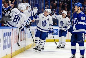Maple Leafs winger Mitch Marner is congratulated at the bench after extending his points streak to a Toronto-record 19 games, against the Tampa Bay Lightning on Saturday night.