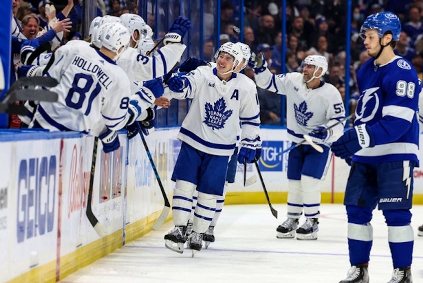 Maple Leafs winger Mitch Marner is congratulated at the bench after extending his points streak to a Toronto-record 19 games, against the Tampa Bay Lightning on Saturday night.