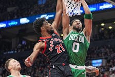 Boston Celtics forward Jayson Tatum (0) dunks against Toronto Raptors forward Thaddeus Young (21) during the first half at Scotiabank Arena. 