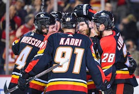 The Calgary Flames celebrate a goal during a 3-2 win over the Arizona Coyotes at the Scotiabank Saddledome in Calgary on Monday, Dec. 5, 2022. 