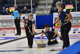 Nova Scotia skip Theresa Breen releases the stone as  Mary Sue Radford, left, and Julie McMullin prepare to sweep at  the Everest Canadian Senior  Curling Championships  at the Yarmouth Mariners Centre.  The Nova Scotia rink advanced to the Championship Pool. TINA COMEAU PHOTO