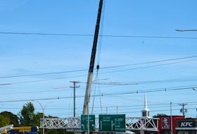 Crews install overhead signs on Route 2, St. Peters Road where the province opened its first displaced left-turn intersection in September 2020. SaltWire Network file
