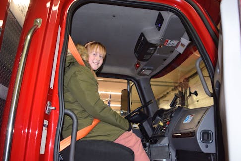 Lily MacDonald got the chance to go for a drive in a fire truck after receiving an award from Muscular Dystrophy Canada. ADAM MACINNIS