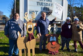 The Flower Cart Group representatives display some wooden Christmas items that will be up for grabs in a prize draw. From left are program participant Jason Foote, chief executive officer Jeff Kelly, and program participants Ashley Muise and Madison Hicks. KIRK STARRATT