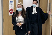 Miranda Lynn Taylor leaves Nova Scotia Supreme Court in Dartmouth with lawyer Alex Pate on Thursday night after a jury found her guilty on two counts of intimidating a justice system participant and one of being an accessory after the fact to murder.