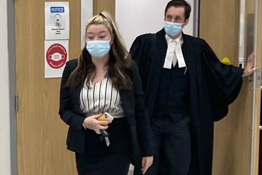 Miranda Lynn Taylor leaves Nova Scotia Supreme Court in Dartmouth with lawyer Alex Pate on Thursday night after a jury found her guilty on two counts of intimidating a justice system participant and one of being an accessory after the fact to murder.