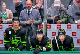 Dallas Stars head coach Peter DeBoer watches his team take on the New York Islanders during the second period at the American Airlines Center. 