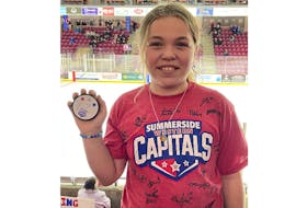 Summerside D. Alex MacDonald Ford Western Capitals’ fan Grace Armsworthy of Crapaud displays a puck autographed by her favourite player, Isaac Wilson, and sports a T-shirt autographed by members of the 2022-23 team. The Caps recently hosted Grace and her family at a Maritime Junior Hockey League (MHL) game at the Island Petroleum Energy Centre. - Margaret Armsworthy/Special to SaltWire Network