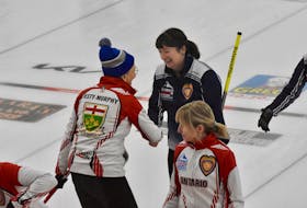 Nova Scotia skip Theresa Breen smiles as she shakes hands with Ontario third Janet Jesty-Murphy after N.S.'s 7-6 win on the last stone of a Dec. 7 draw between the two teams. The win solidified N.S.'s first-place finish in its round-robin pool. TINA COMEAU PHOTO
