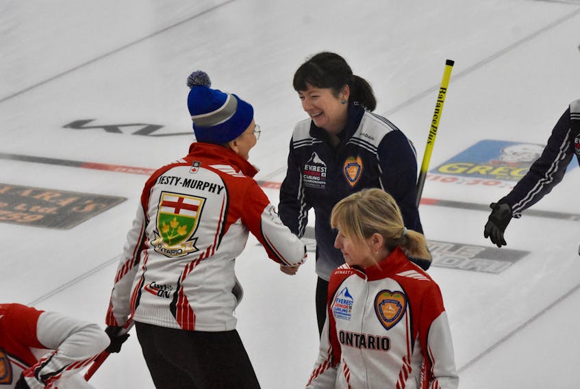 Nova Scotia skip Theresa Breen smiles as she shakes hands with Ontario third Janet Jesty-Murphy after N.S.'s 7-6 win on the last stone of a Dec. 7 draw between the two teams. The win solidified N.S.'s first-place finish in its round-robin pool. TINA COMEAU PHOTO
