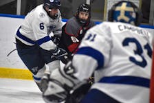 Ryland Hanrahan of the Glace Bay Panthers, middle, looks towards the net as he’s pressured by Keagan Corbett of the Sydney Academy Wildcats, left, during Day 1 of the Panther Classic high school hockey tournament at the Miners Forum in Glace Bay, Thursday. JEREMY FRASER/CAPE BRETON POST.