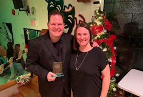 Stephen Muise, left, is shown with Keli Brewer, who presented him with the Canadian Band Association Community Builders award during the Breton Education Centre Christmas concert on Wednesday. CONTRIBUTED