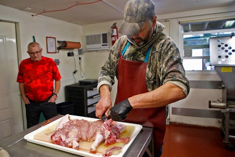 Grant Cavicchi look a on as Gerry Zwicker makes a turducken, for story on the preparation of a turducken, at Cavicchi Meats in Upper Tantallon Wednesday December 7, 2022. 

TIM KROCHAK PHOTO