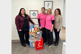 Taylor Smiles orthodontic clinic presents two containers of food donated as part of their food drive to Joy Connors of the Bay of Islands Food Bank. Their drive is underway until Dec. 15. From left, Melissa Curtis, Nancy Bugden, Natasha Barker and Joy Connors. CONTRIBUTED