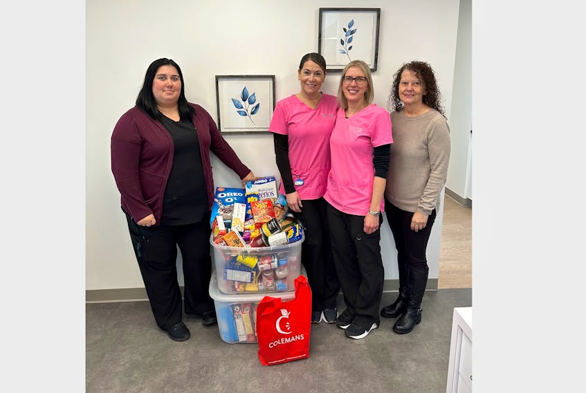 Taylor Smiles orthodontic clinic presents two containers of food donated as part of their food drive to Joy Connors of the Bay of Islands Food Bank. Their drive is underway until Dec. 15. From left, Melissa Curtis, Nancy Bugden, Natasha Barker and Joy Connors. CONTRIBUTED