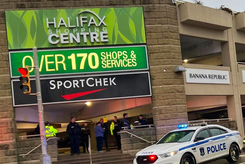 Police talk to witnesses after a youth was injured in an altercation near the Halifax Shopping Centre's parkade on Mumford Road Dec. 9, 2022.