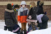  Children in the schoolyard outside Garneau School in Edmonton on Thursday, January 20, 2022.