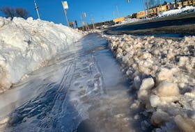 Ice covers the sidewalk at a bus stop on Atlantic Street in Woodside Tuesday Feb 1, 2022.