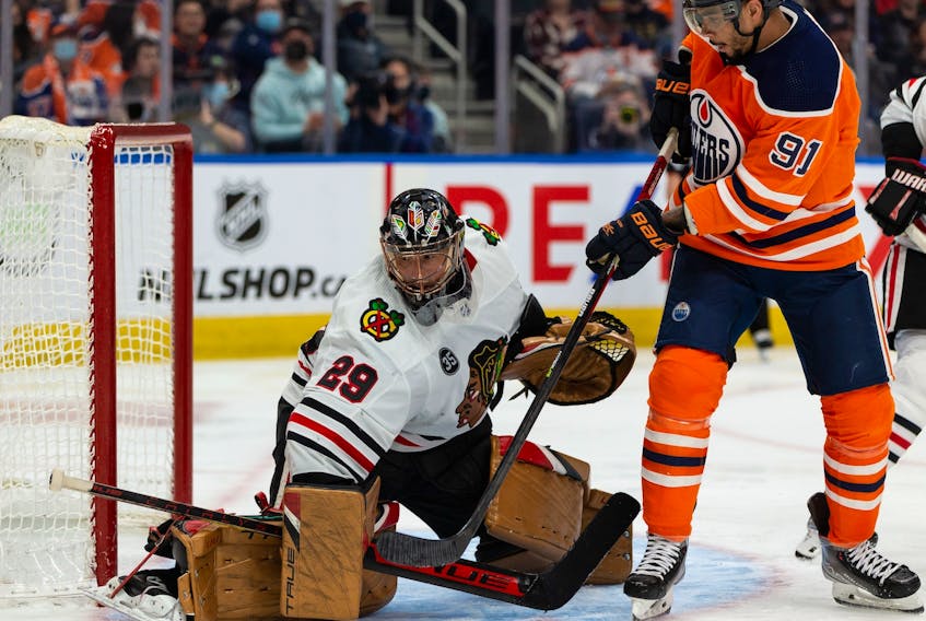Edmonton Oilers’ Evander Kane (91) battles Chicago Blackhawks’ goaltender Marc-Andre Fleury (29) during third period NHL action at Rogers Place in Edmonton, on Wednesday, Feb. 9, 2022. Photo by 