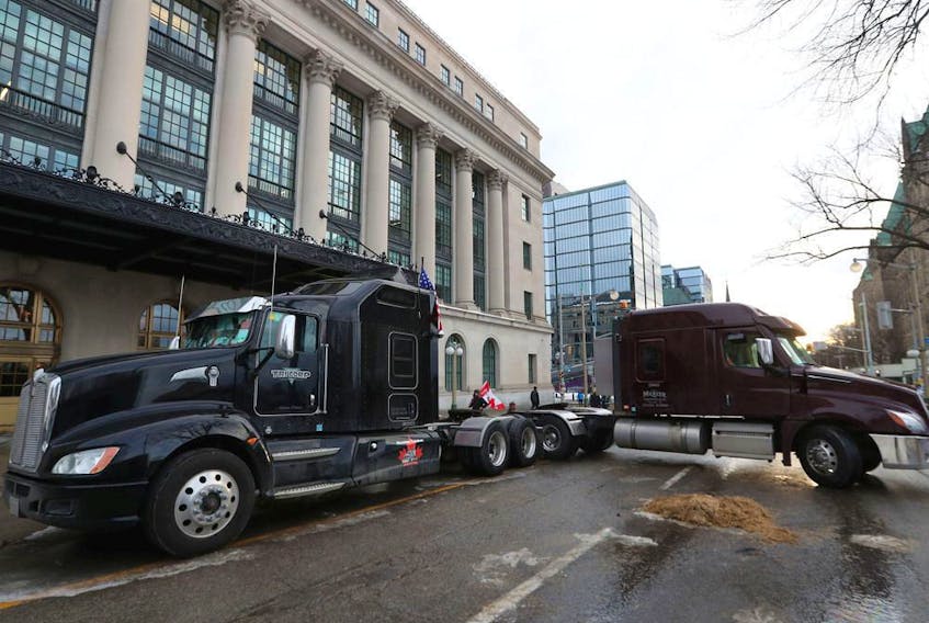  Two big rigs block a downtown Ottawa street again on Thursday.