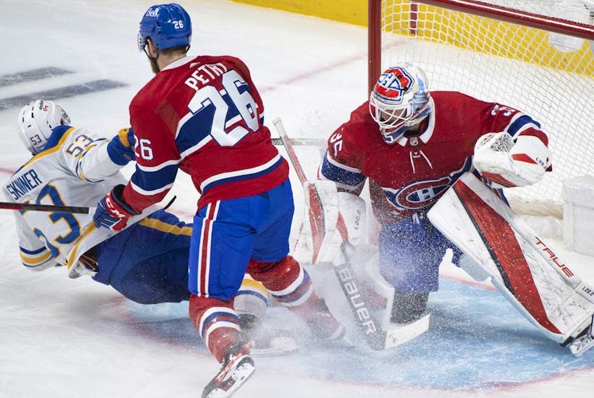 Canadiens goaltender Sam Montembeault is scored on by Buffalo Sabres' Jeff Skinner (53) as Canadiens' Jeff Petry defends during third period NHL hockey action in Montreal on Sunday, Feb. 13, 2022.