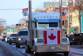 A semi truck drives down Great George Street ahead of a line of vehicles during a slow roll through Charlottetown on Feb. 12.