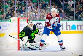 Colorado Avalanche centre Nathan MacKinnon screens Dallas Stars goaltender Braden Holtby during the third period of Sunday's NHL game at the American Airlines Center.