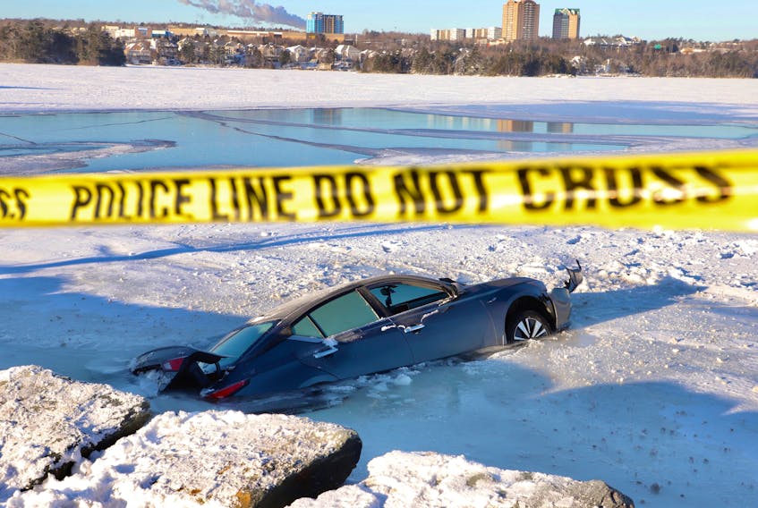 /The driver of this car escaped injury after their car left Waverly Road in Dartmouth and crashed through the ice on Lake Mic Mac just after midnight on Feb. 16, 2022/