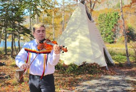 Morgan Toney, a Mi’kmaq fiddling sensation originally from We’koma’q First Nation, plays at Goat Island in Eskasoni before shooting a music video for his new song. Chris Connors/Cape Breton Post